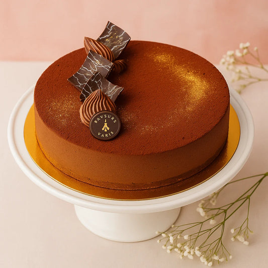 Brazil cake with decorative elements on a white stand against a soft pink background Saveur De paris